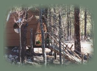 the abbey, one of many cabins to be found at gathering light, a retreat located in southern oregon near crater lake national park and klamath basin birding trails. cabins, vacation rentals, tree houses and rv camping in the forest on the river located near crater lake national park and klamath basin birding trails in southern oregon.