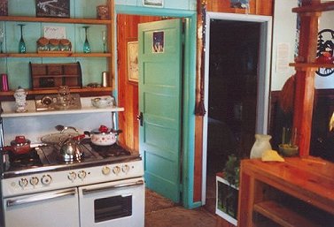 Kitchen in the cottage -- antique gas range, knotty pine, antique furnishings - at Gathering Light ... a retreat for nature lovers
gathering light, a retreat offering cabins near crater lake national park and klamath basin birding trails in southern oregon. cabins, tree houses, rv camping and vacation rentals in the forest on the river near crater lake national park and klamath basin birding trails.